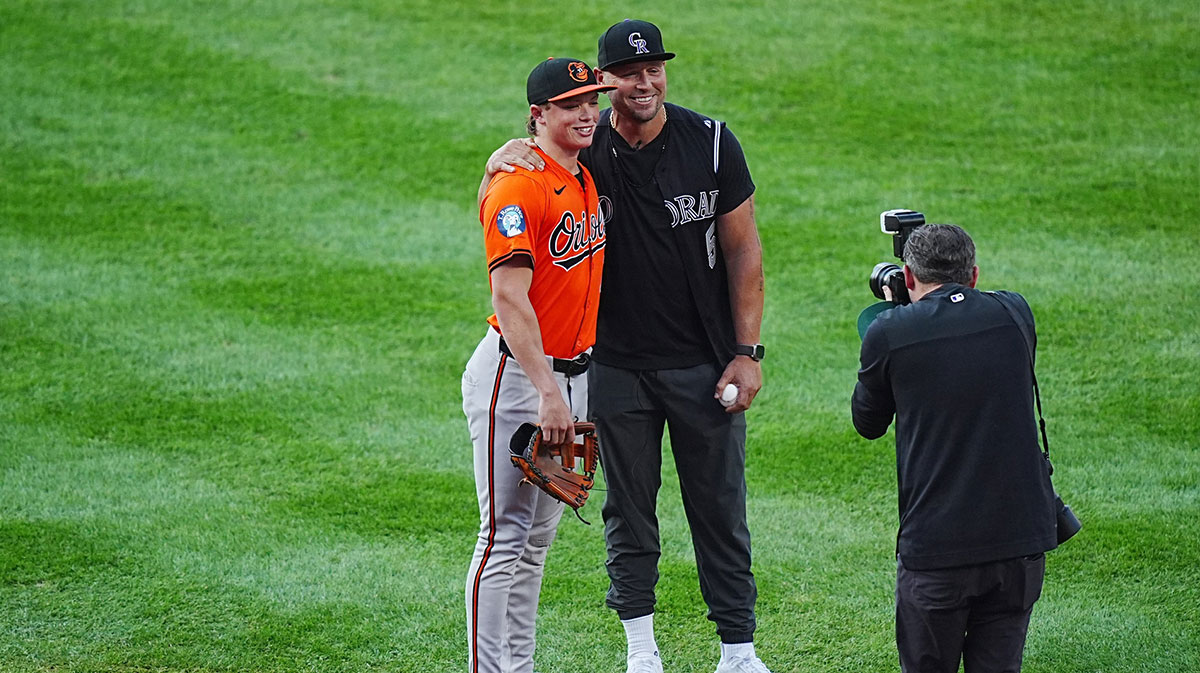 Colorado Rockies team photographer Kyle Coopah poses Baltimore Orioles second base Jackson Holliday (7) and his father retired American baseball player Matt Holliday at Coors Field. 