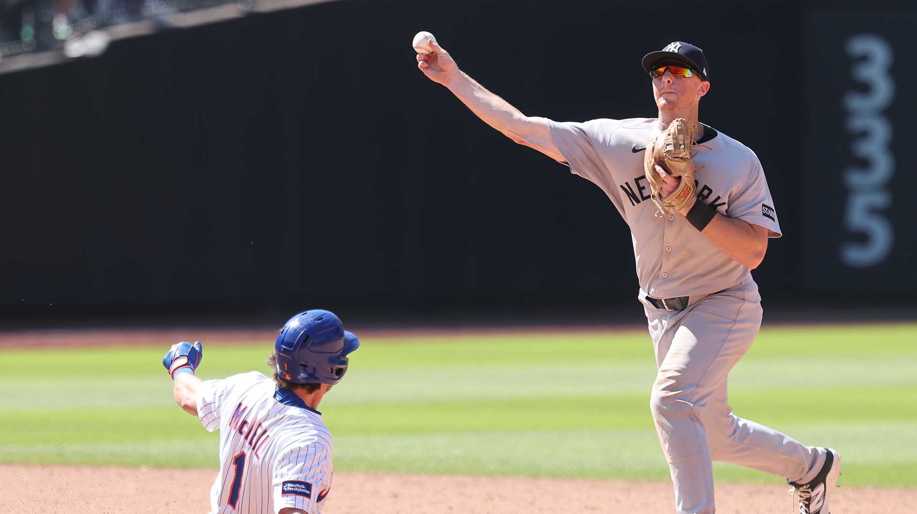 New York Yankees second baseman DJ LeMahieu (26) forces out New York Mets second baseman Jeff McNeil (1) at second base and throws to first to complete the double play on a ball hit by catcher Hayden Senger (not pictured) during the sixth inning at Citi Field. Mets pinch hitter Ronny Mauricio (np) scored on the play.