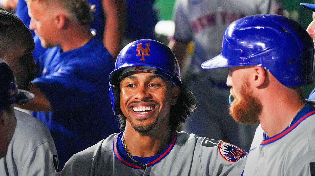 New York Mets shortstop Francisco Lindor (12) celebrates in the dugout after scoring against the Kansas City Royals in the ninth inning at Kauffman Stadium.