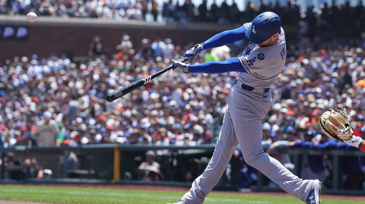 Jul 12, 2025; San Francisco, California, USA; Los Angeles Dodgers first baseman Freddie Freeman (5) hits a double against the San Francisco Giants during the first inning at Oracle Park.
