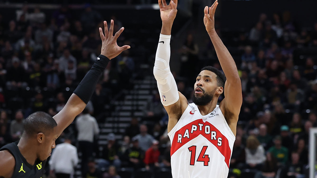 Toronto Raptors forward Garrett Temple (14) shoots over Utah Jazz guard Kris Dunn (11) during the fourth quarter at Delta Center.
