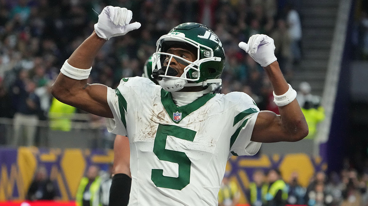 New York Jets wide receiver Garrett Wilson (5) celebrates after scoring on a 1-yard touchdown reception against the New York Jets in the fourth quarter at Tottenham Hotspur Stadium.