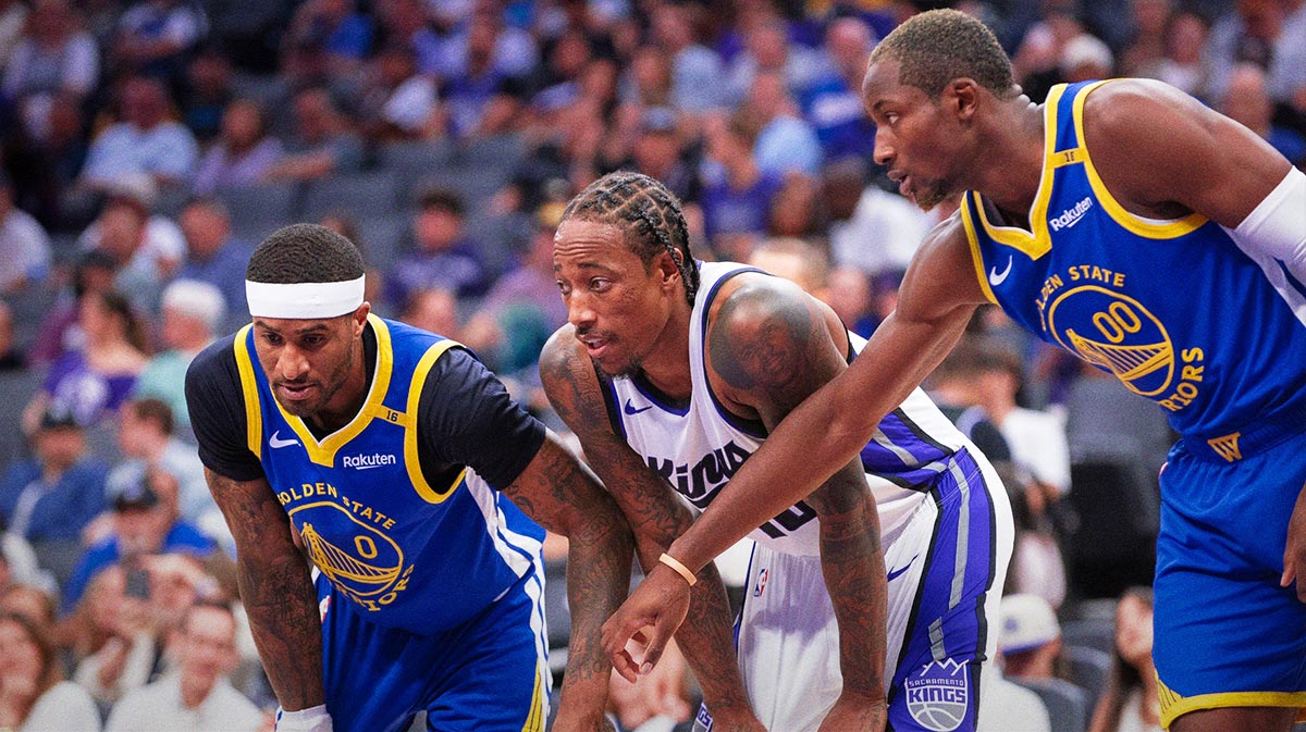 Golden State Warriors guard Gary Payton II (0) and forward Jonathan Kuminga (00) defend against Sacramento Kings forward DeMar DeRozan (10) during a free throw attempt in the second quarter at Golden 1 Center.