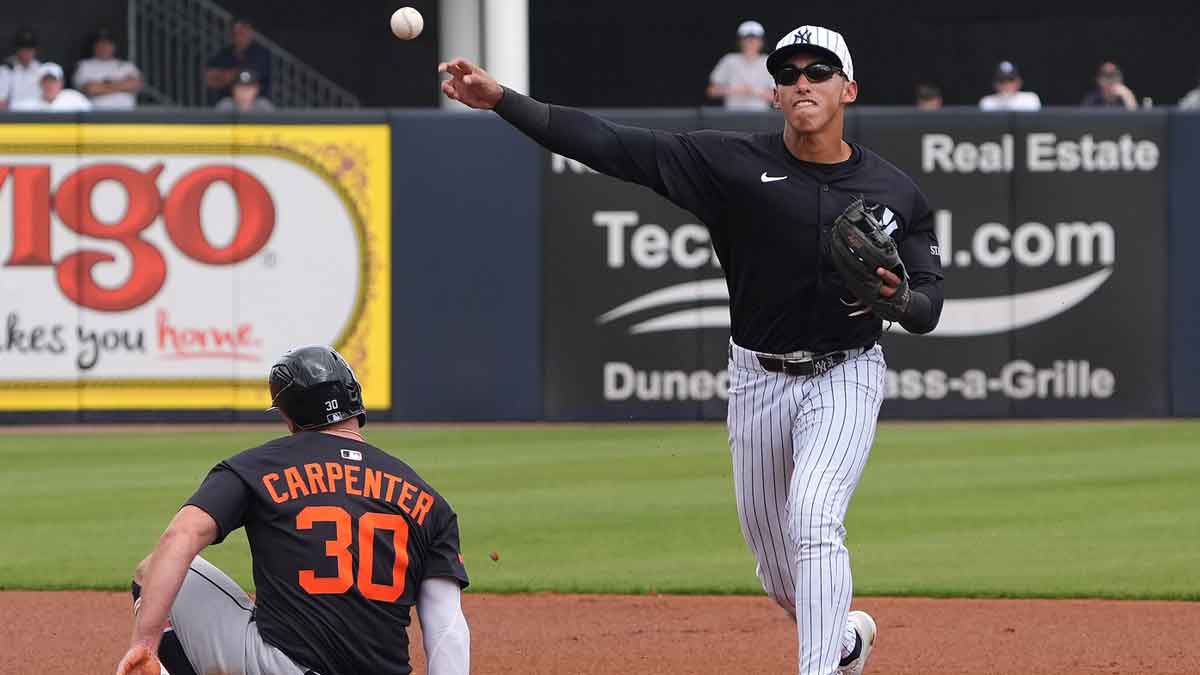 New York Yankees shortstop George Lombard Jr. (96) throws to first to make the double play as Detroit Tigers outfielder Kerry Carpenter (30) slides into second during the first inning at George M. Steinbrenner Field.