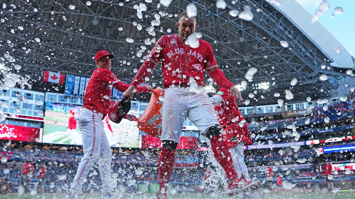Toronto Blue Jays right fielder George Springer (4) gets the water bucket poured on him at the end of the ninth inning against the New York Yankees at Rogers Centre.