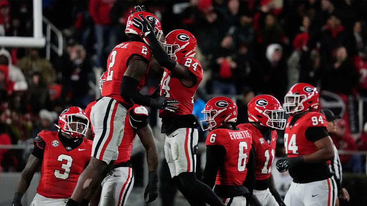 Georgia linebacker Smael Mondon Jr. (2) and Georgia defensive back Malaki Starks (24) celebrate after making a stop during the first half of a NCAA college football game against Georgia Tech in Athens, Ga., on Friday, Nov. 29, 2024.