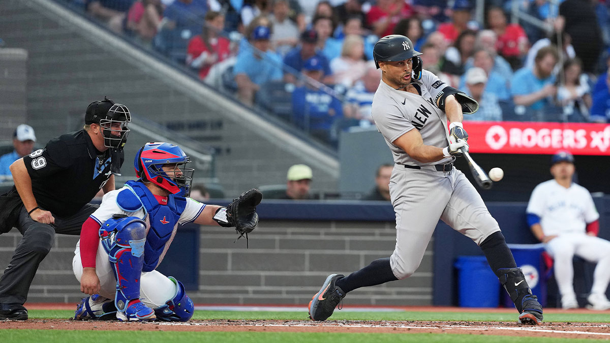 New York Yankees designated hitter Giancarlo Stanton (27) hits a home run against the Toronto Blue Jays during the fourth inning at Rogers Centre.