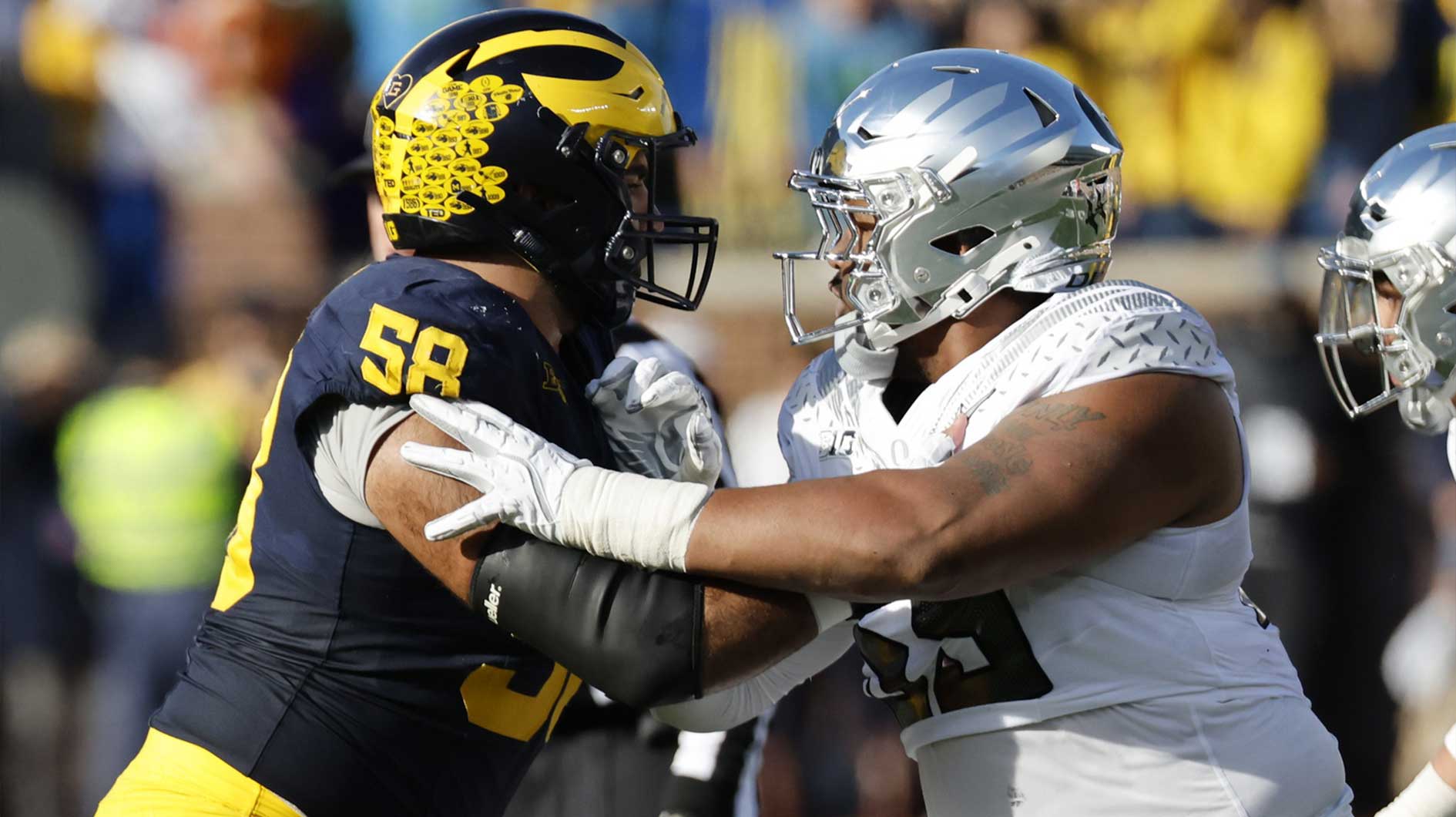 Michigan Wolverines offensive lineman Giovanni El-Hadi (58) blocks Oregon Ducks defensive lineman Derrick Harmon (55) in the first half at Michigan Stadium.