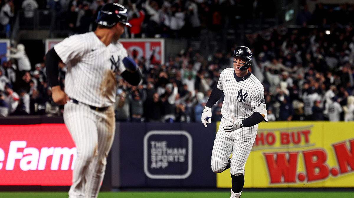 New York Yankees outfielder Aaron Judge (99) celebrates with New York Yankees second base Gleyber Torres (25) after hitting a two run home run during the seventh inning against the Cleveland Guardians in game two of the ALCS for the 2024 MLB Playoffs at Yankee Stadium.