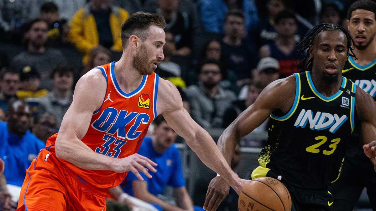 Oklahoma City Thunder forward Gordon Hayward (33) dribbles the ball while Indiana Pacers forward Aaron Nesmith (23) defends in the first half at Gainbridge Fieldhouse.