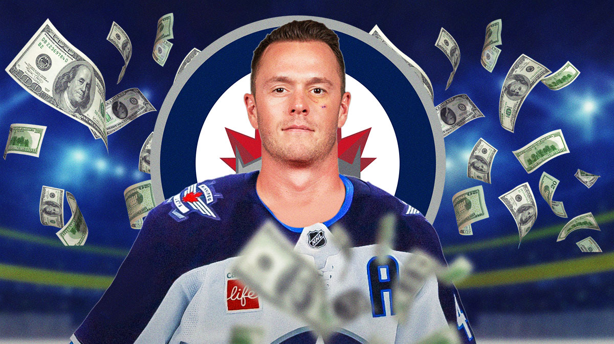 Jonathan Toews in a Winnipeg Jets jersey with money around him and the JEts logo in the background.