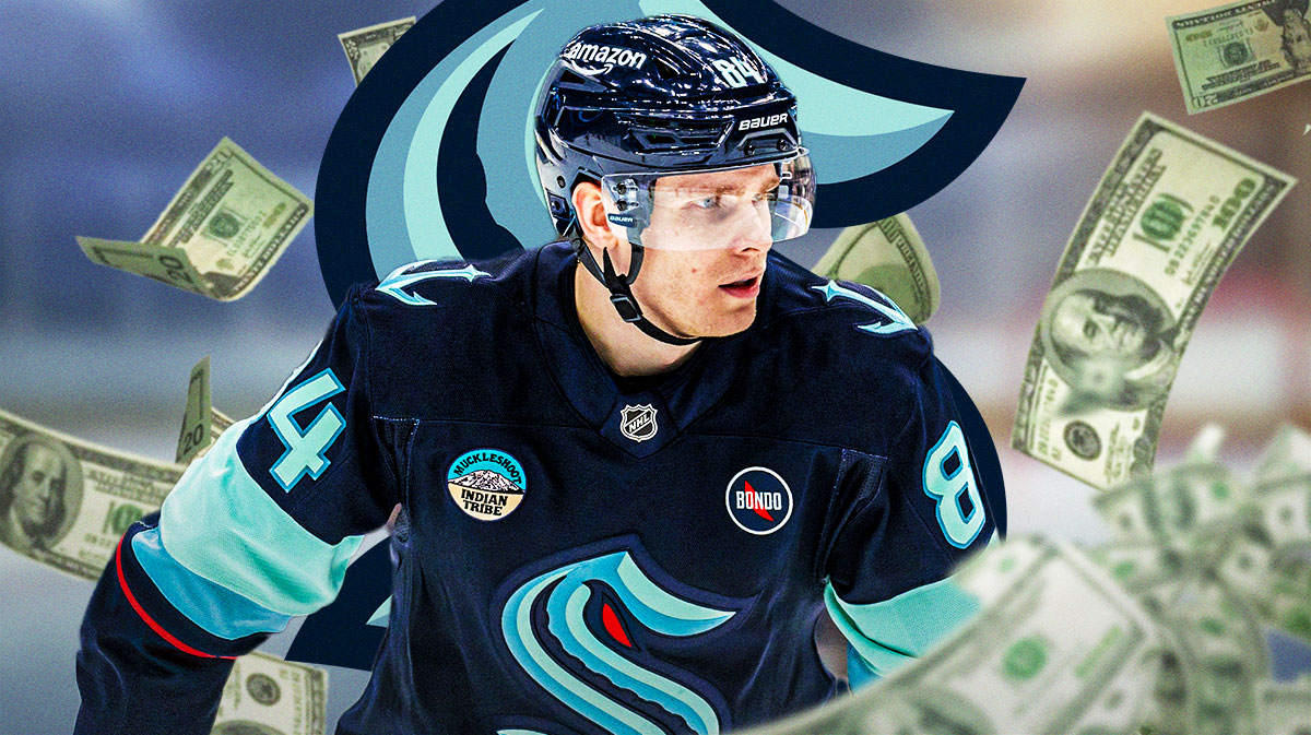 Kaapo Kakko with money around him and kraken logo in the background, NHL