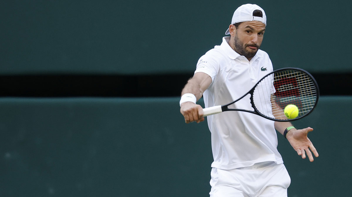 Grigor Dimitrov (BUL) hits a backhand against Jannik Sinner (ITA)(not pictured) on day eight of The Championships Wimbledon 2025 at All England Lawn Tennis and Croquet Club.