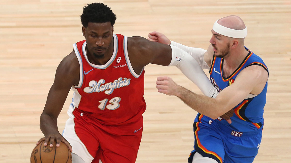 Grizzlies forward Jaren Jackson Jr. (13) dribbles as Oklahoma City Thunder guard Alex Caruso (9) defends during the first quarterduring game four for the first round of the 2024 NBA Playoffs at FedExForum