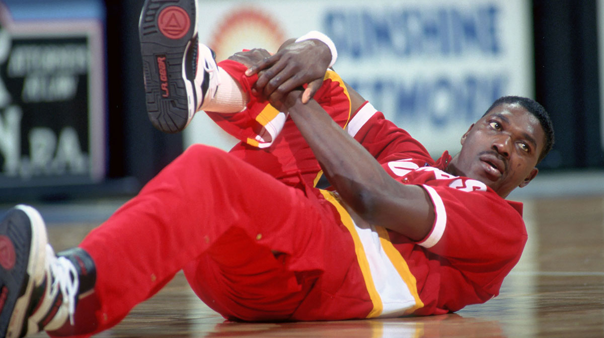 Houston Rockets center #34 HAKEEM OLAJUWON stretches before his game against the Orlando Magic at the Orlando Arena.