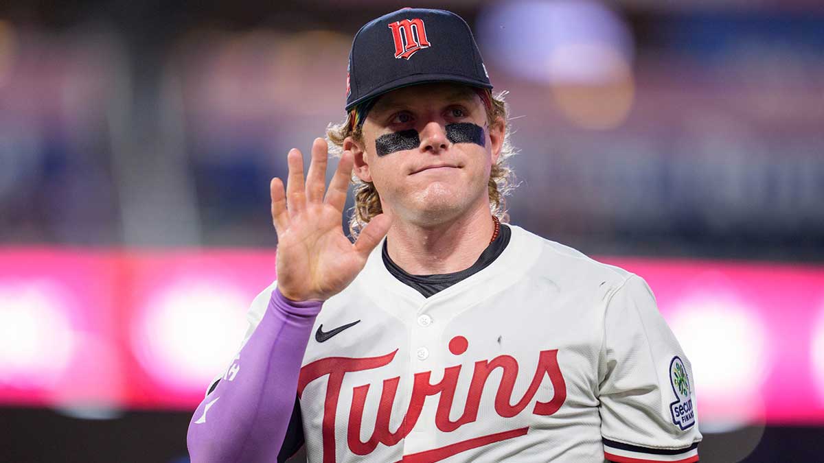 Minnesota Twins left fielder Harrison Bader (12) waves at a fan while walking to the dugout after the ninth inning against the Washington Nationals at Target Field.
