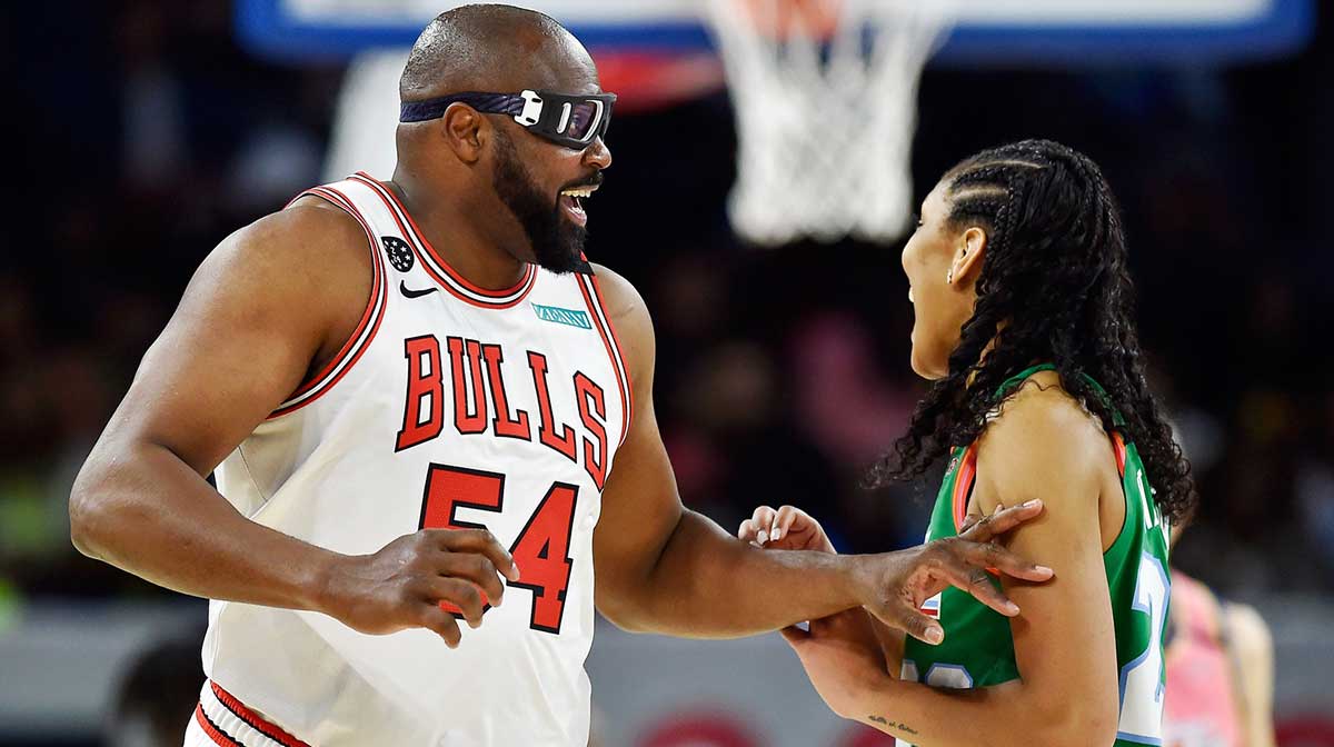 Former Chicago Bulls player Horace Grant, playing for Team Wilbon, laughs with Team Stephen A. player A ja Wilson during the NBA All Star-Celebrity Game at Wintrust Arena.