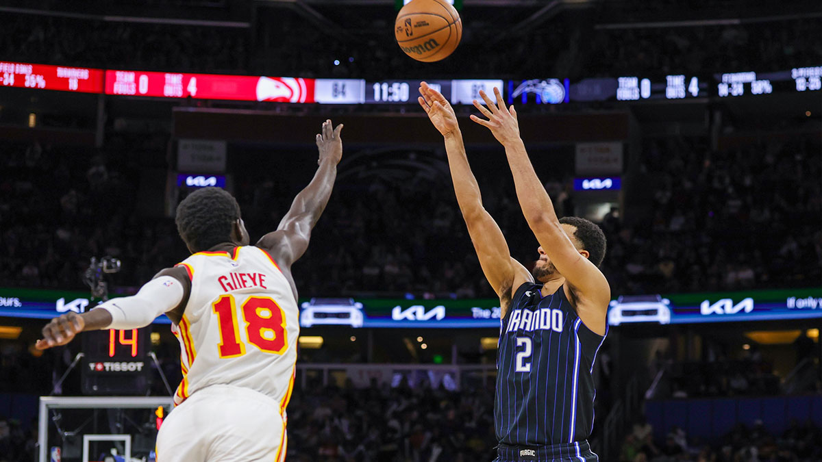 Orlando Magic guard Caleb Houstan (2) shoots a three point basket against Atlanta Hawks forward Mouhamed Gueye (18) during the second half at Kia Center.