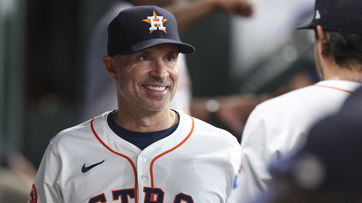 Houston Astros manager Joe Espada (19) smiles in the dugout before the game against the Chicago Cubs at Daikin Park.