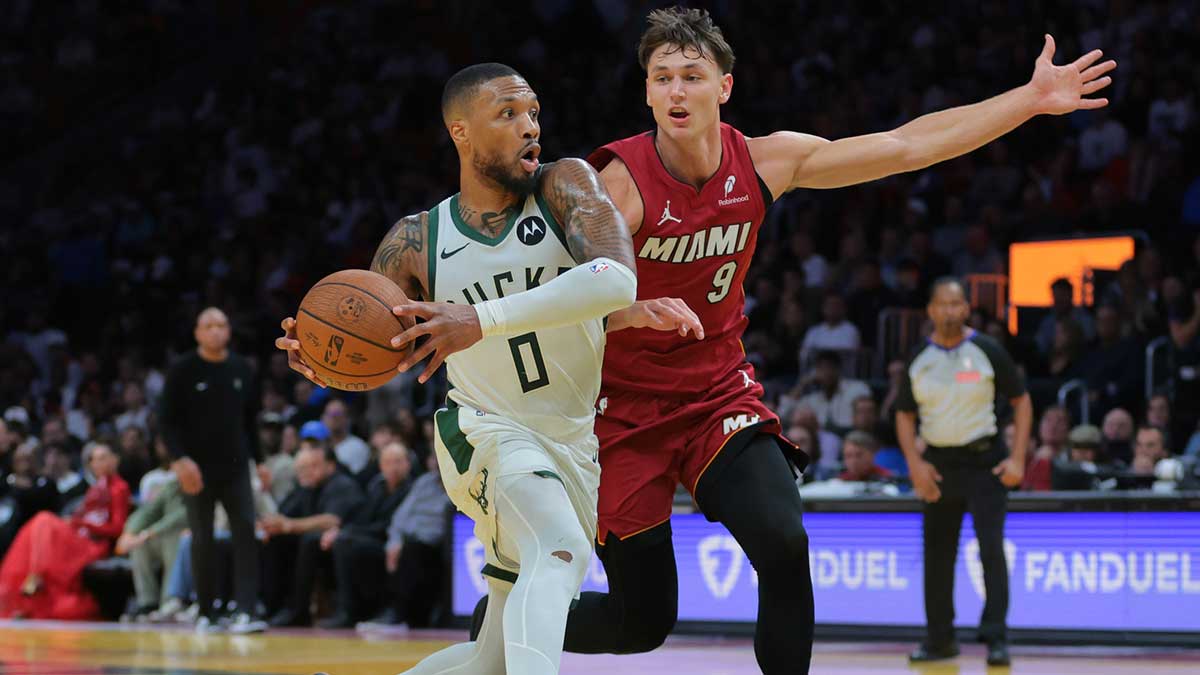 Milwaukee Bucks guard Damian Lillard (0) drives to the basket against Miami Heat guard Pelle Larsson (9) during the third quarter at Kaseya Center.