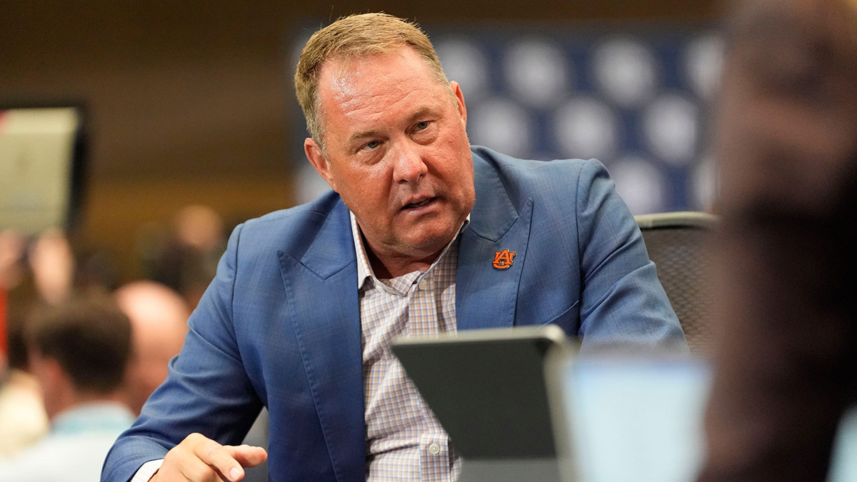 Auburn head coach Hugh Freeze talks to ESPN personalities on set during SEC Media Days at the College Football Hall of Fame.
