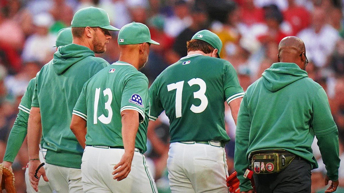 Boston Red Sox pitcher Hunter Dobbins (73) is taken out of the game after being hurt after a play at first against the Tampa Bay Rays in the second inning at Fenway Park.