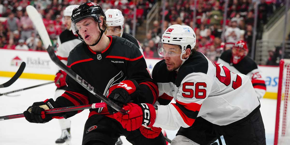 Carolina Hurricanes right wing Jackson Blake (53) and New Jersey Devils left wing Erik Haula (56) battle during the third period in game five of the first round of the 2025 Stanley Cup Playoffs at Lenovo Center.