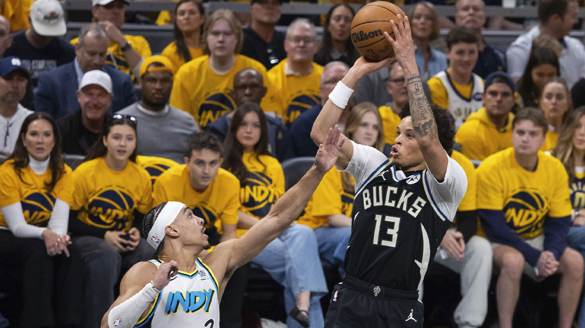 Milwaukee Bucks guard Ryan Rollins (13) shoots the ball while Indiana Pacers guard Andrew Nembhard (2) defends in the first half at Gainbridge Fieldhouse.