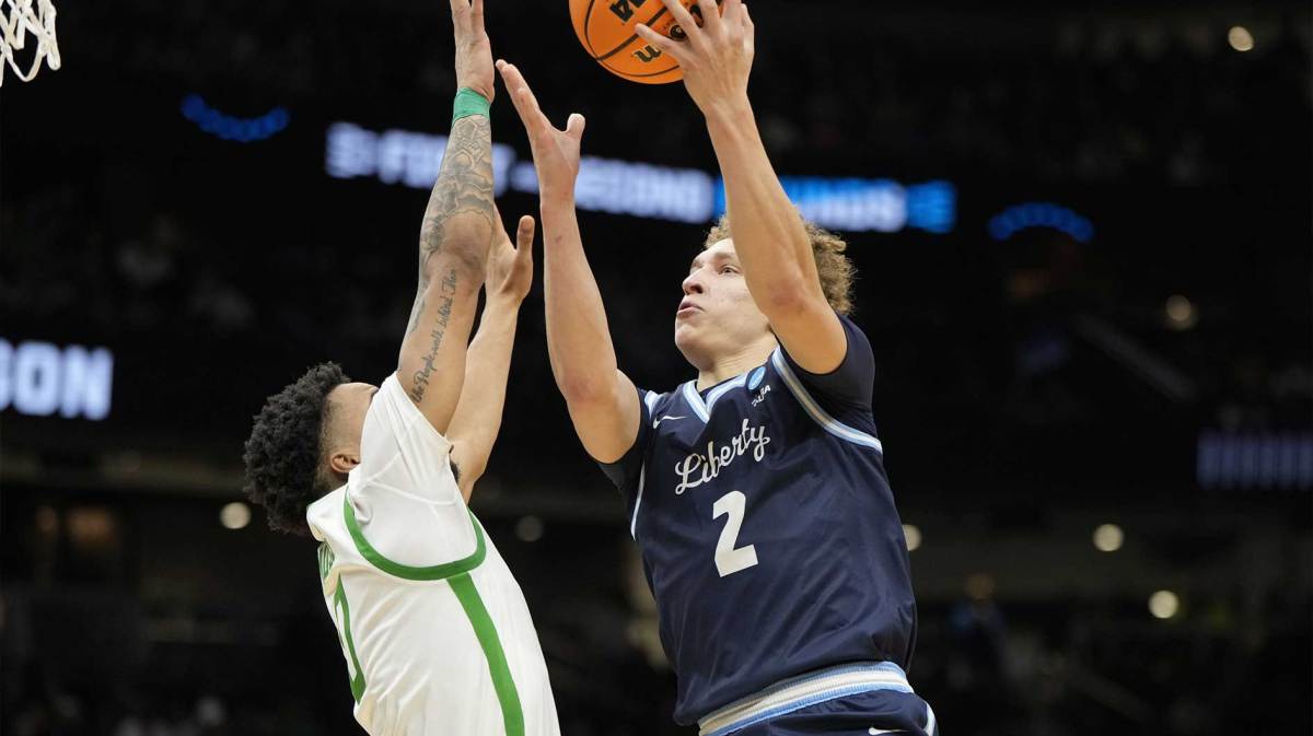 Liberty Flames guard Taelon Peter (2) shoots the ball over Oregon Ducks guard Ra'Heim Moss (0) during the second half in the first round of the NCAA Tournament at Climate Pledge Arena.
