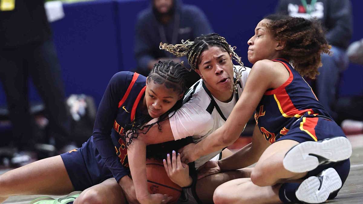 Purcell Marian players Ky'Aira Miller (3) and McKenzie Jones (12) battles Laurel School forward Saniyah Hall for a loose ball during their state championship game Saturday, March 16, 2024.