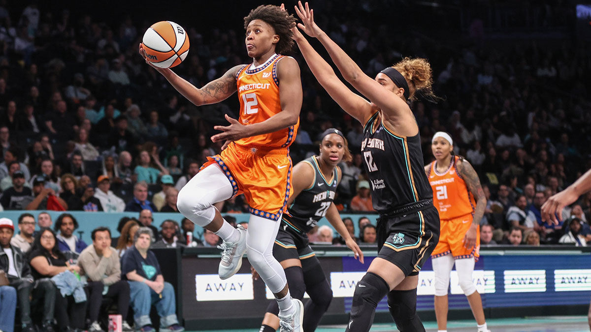 Connecticut Sun guard Yvonne Anderson (12) drives past New York Liberty forward Esmery Martinez (12) in the fourth quarter at Barclays Center.