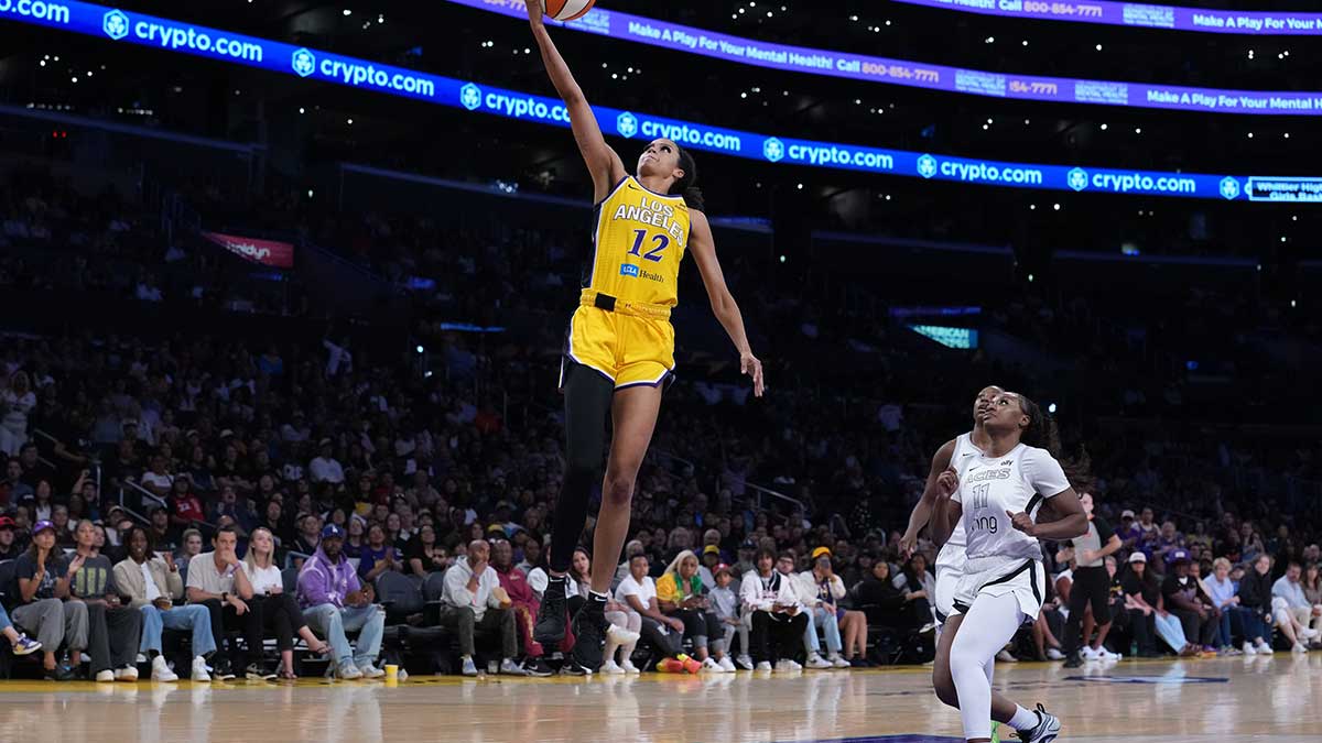 LA Sparks guard Rae Burrell (12) shoots the ball against Las Vegas Aces guard Dana Evans (11) in the first half at Crypto.com Arena.