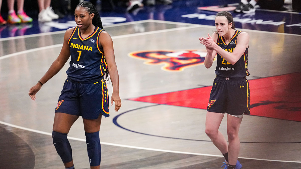 Indiana Fever guard Caitlin Clark (22) claps her hands in excitement with Indiana Fever forward Aliyah Boston (7).
