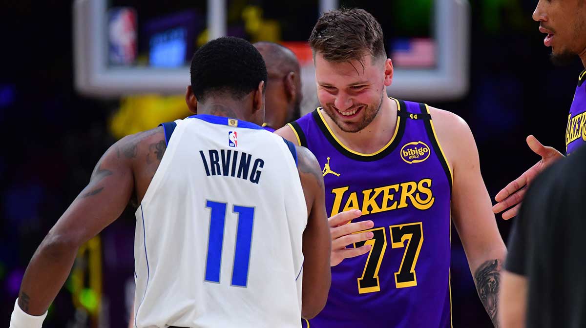 Los Angeles Lakers guard Luka Doncic (77) reacts with Dallas Mavericks guard Kyrie Irving (11) during the first quarter at Crypto.com Arena.