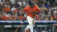 Houston Astros third baseman Isaac Paredes (15) hits a single during the first inning against the Texas Rangers at Daikin Park.