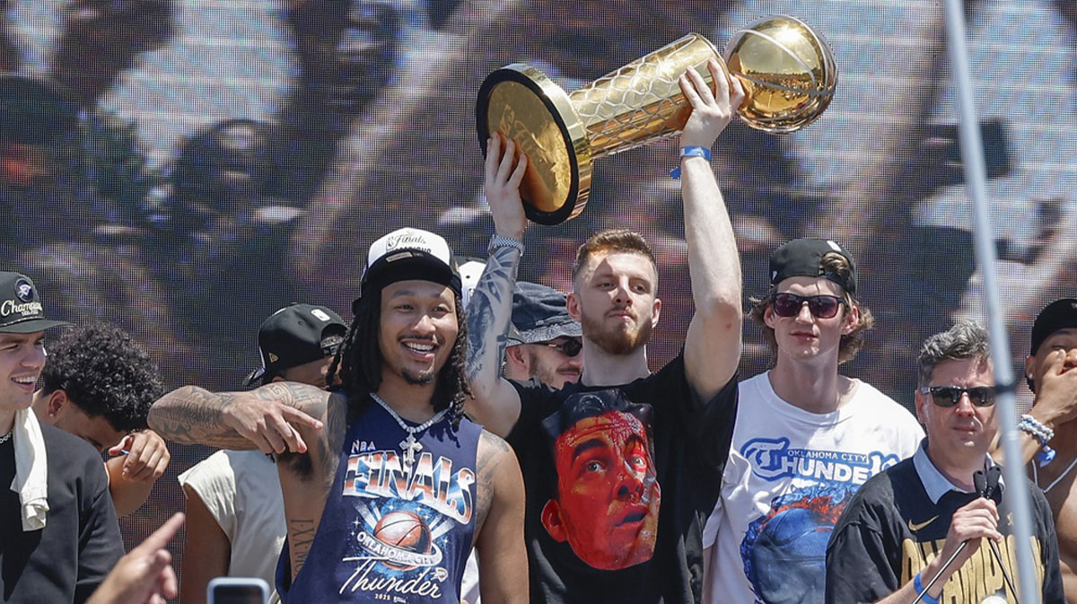 Oklahoma City Thunder center Isaiah Hartenstein holds the Larry O'Brien Championship Trophy during the Oklahoma City Thunder Champions parade.