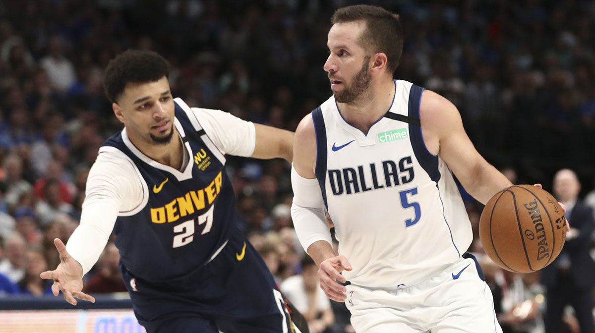 Dallas Mavericks guard J.J. Barea (5) dribbles as Denver Nuggets guard Jamal Murray (27) defends during the second quarter at American Airlines Center.