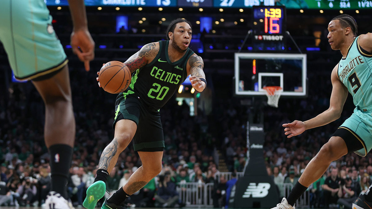 Boston Celtics guard JD Davison (20) dribbles down the court during the first half against the Charlotte Hornets at TD Garden.