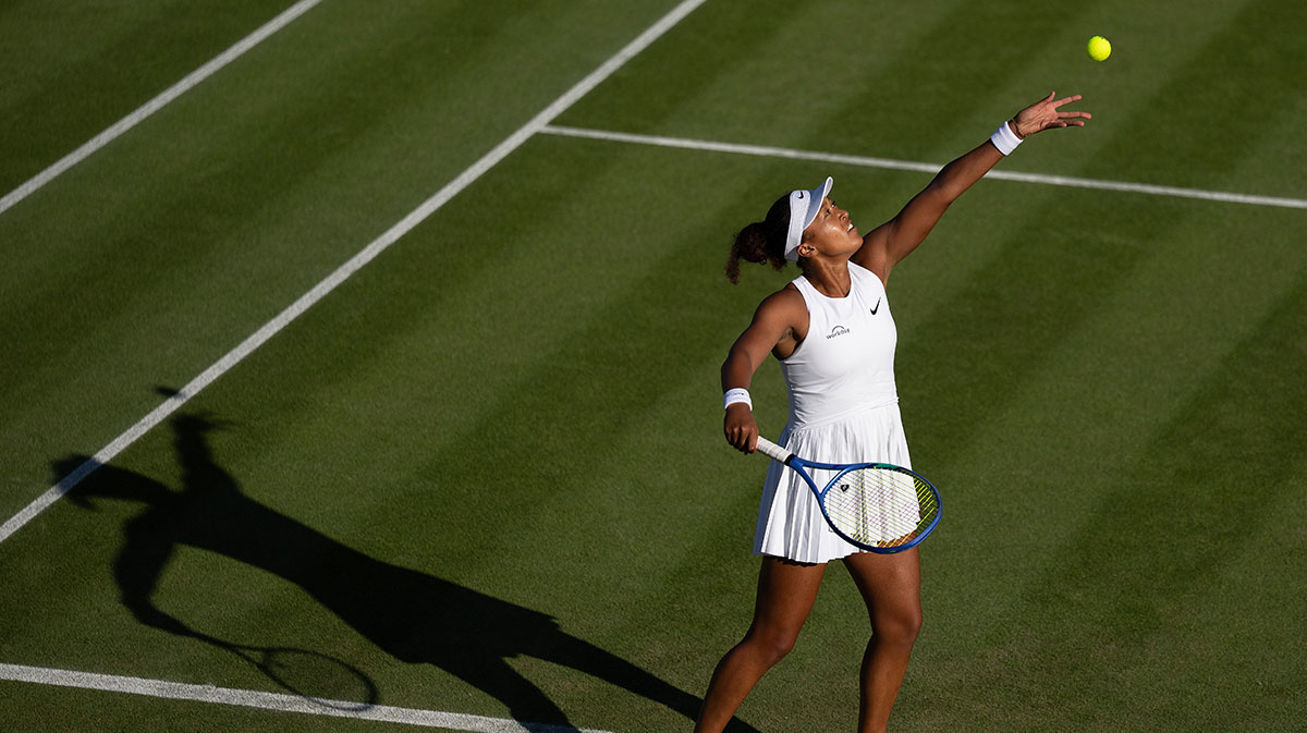Jul 2, 2025; Wimbledon, United Kingdom; Naomi Osaka of Japan tosses the ball to serve during her match against Katerina Siniakova of the Czech Republic on day three at the All England Lawn Tennis and Croquet Club. Mandatory Credit: Susan Mullane-Imagn Images