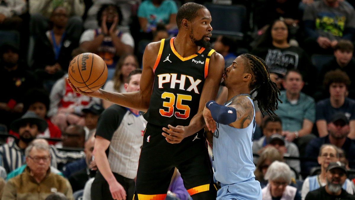 Phoenix Suns forward Kevin Durant (35) handles the ball as Memphis Grizzlies guard Ja Morant (12) defends during the first quarter at FedExForum.