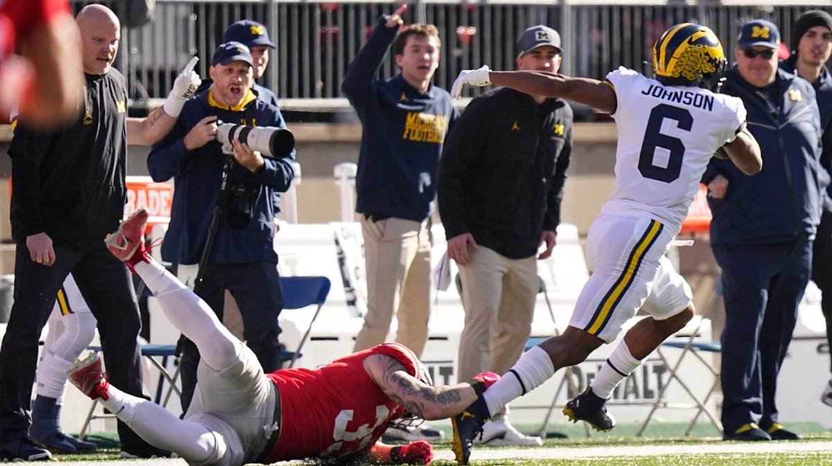 Michigan Wolverines wide receiver Cornelius Johnson (6) escapes tackle by Ohio State Buckeyes defensive end Jack Sawyer (33) on his way to the endzone for a touchdown during the first half of the NCAA football game at Ohio Stadium.