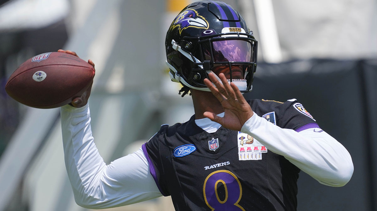 Baltimore Ravens quarterback Lamar Jackson (8) warms up during training camp at Under Armour Performance Center.