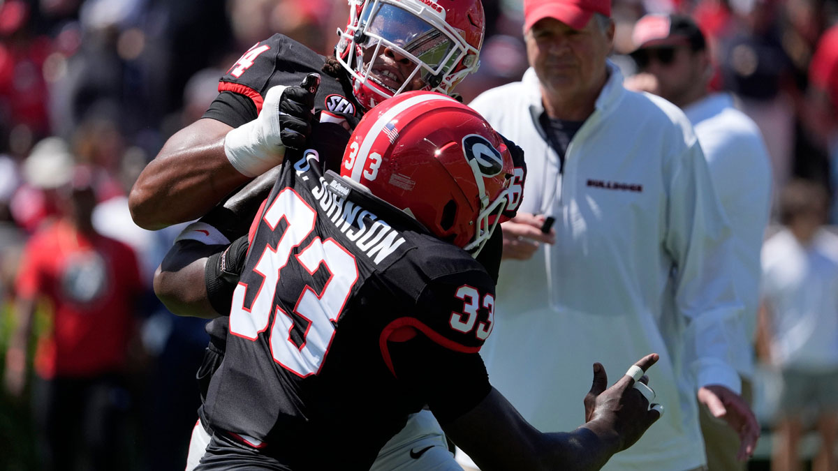 Georgia outside linebacker Quintavius Johnson warms up with Georgia offensive lineman Jahzare Jackson (64) before the start of the Georgia G-Day spring football game in Athens, Ga., on Saturday, April 12, 2025.