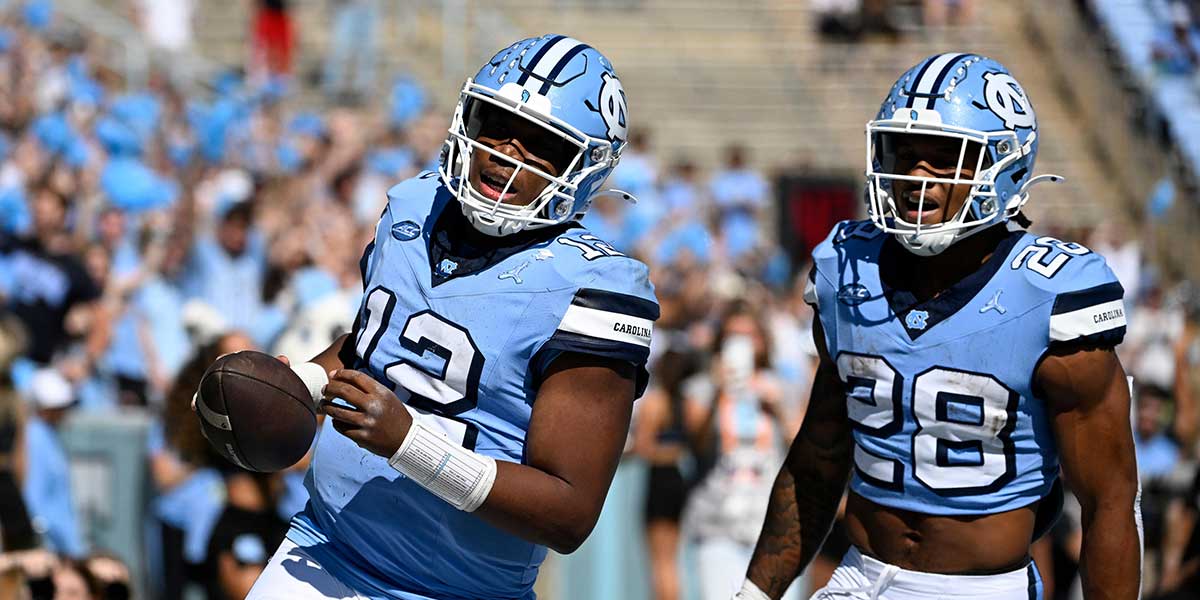 North Carolina Tar Heels quarterback Jacolby Criswell (12) celebrates with running back Omarion Hampton (28) after scoring a touchdown in the first quarter at Kenan Memorial Stadium.