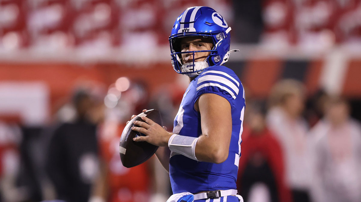 Brigham Young Cougars quarterback Jake Retzlaff (12) warms up before a game against the Utah Utes at Rice-Eccles Stadium.
