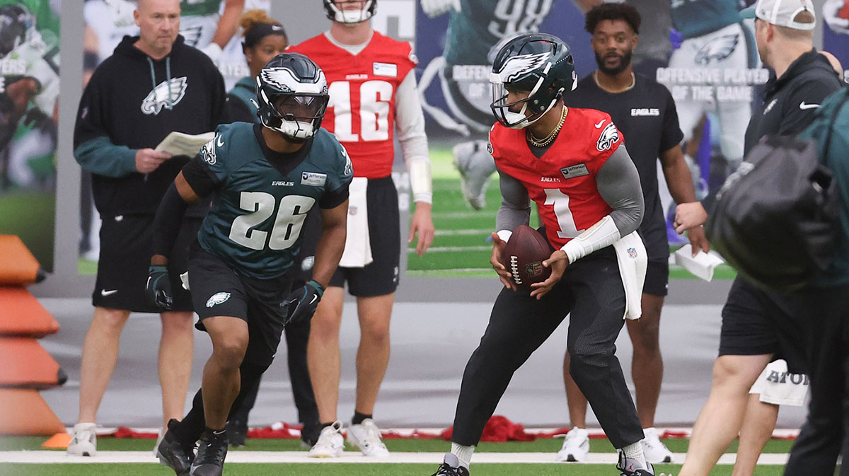 Philadelphia Eagles quarterback Jalen Hurts (1) hands off to running back Saquon Barkley (26) during OTAs at NovaCare Complex.