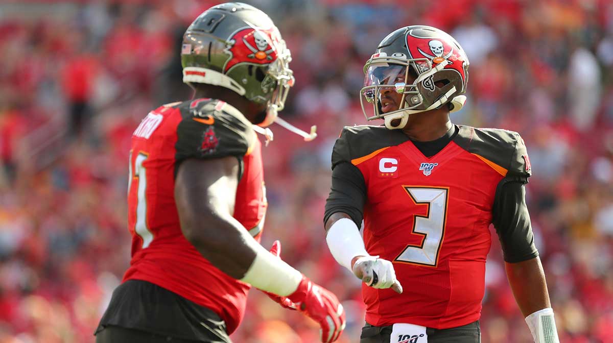 Tampa Bay Buccaneers quarterback Jameis Winston (3) celebrates with offensive guard Earl Watford (71) after a touchdown against the Atlanta Falcons during the first half at Raymond James Stadium.