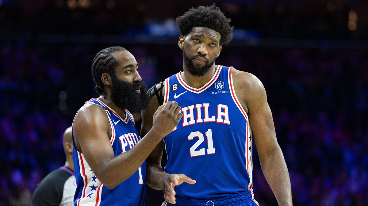 Philadelphia 76ers guard James Harden (1) and center Joel Embiid (21) talks during a break in the fourth quarter against the Orlando Magic at Wells Fargo Center.