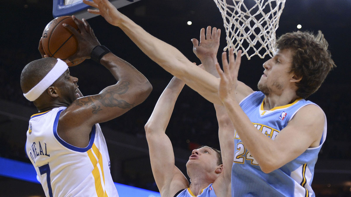 Golden State Warriors center Jermaine O'Neal (7) is defended by Denver Nuggets center Timofey Mozgov (25) and forward Jan Vesely (24) during the third quarter at Oracle Arena. The Nuggets defeated the Warriors 100-99. 