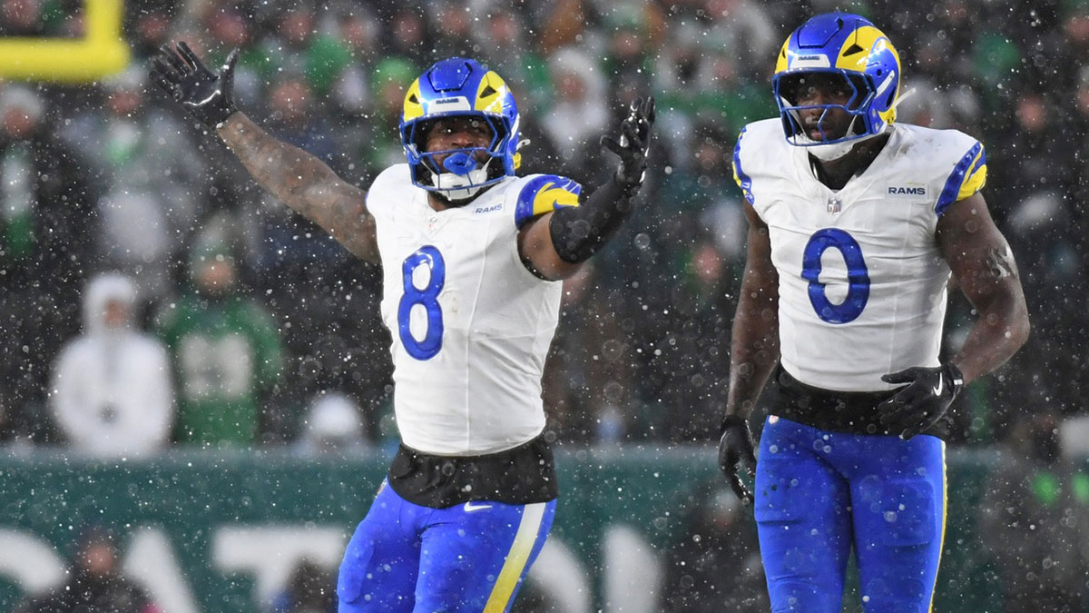 Los Angeles Rams linebacker Jared Verse (8) and linebacker Byron Young (0) celebrate a sack against the Philadelphia Eagles in a 2025 NFC divisional round game at Lincoln Financial Field.